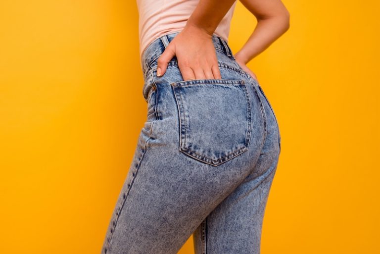 Woman in jeans with hands in back pocket